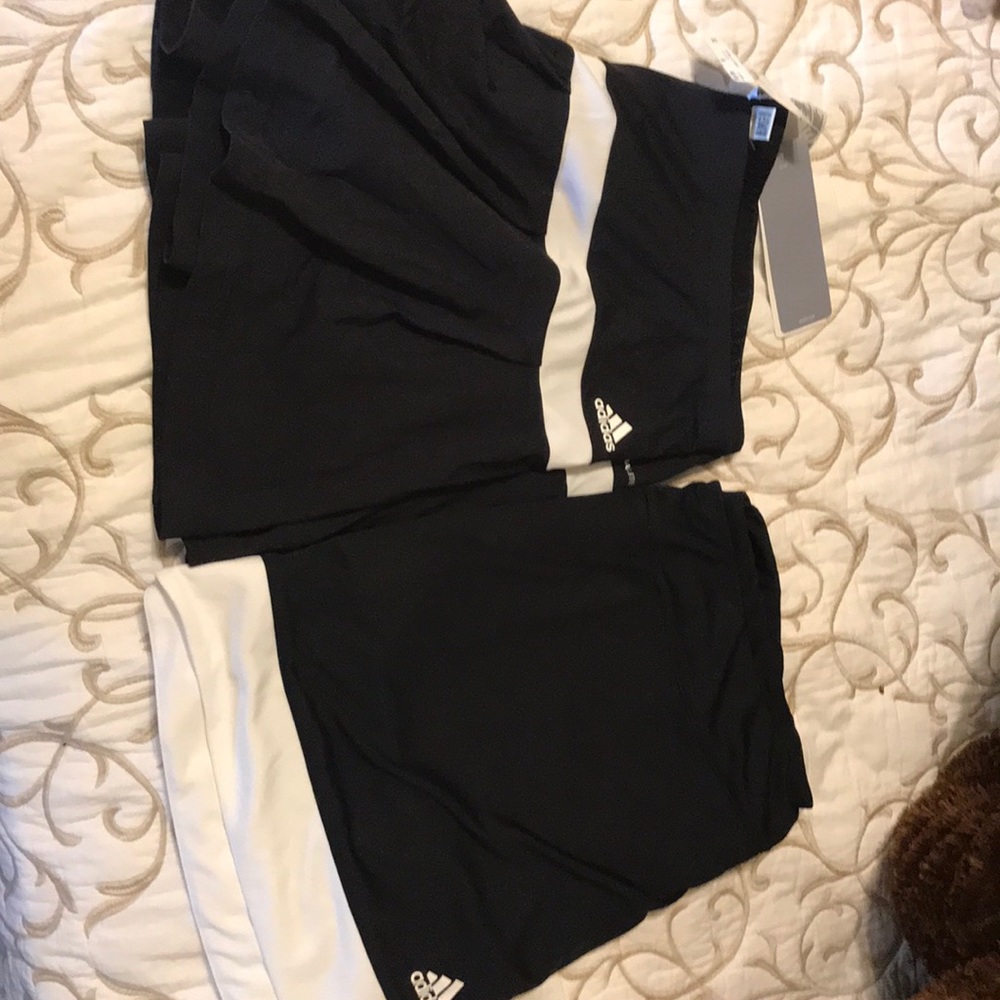 Two adidas skirts. One with tags